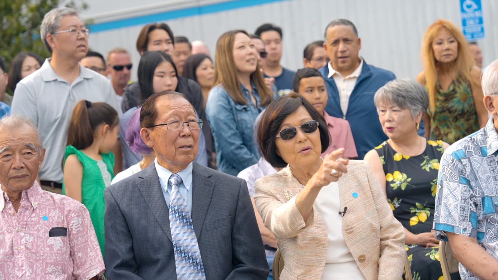 Community members seated together at the centennial celebration