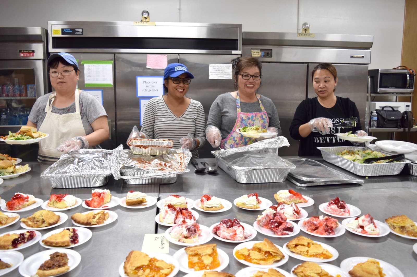 Volunteers plating pies and dinners in the center's kitchen