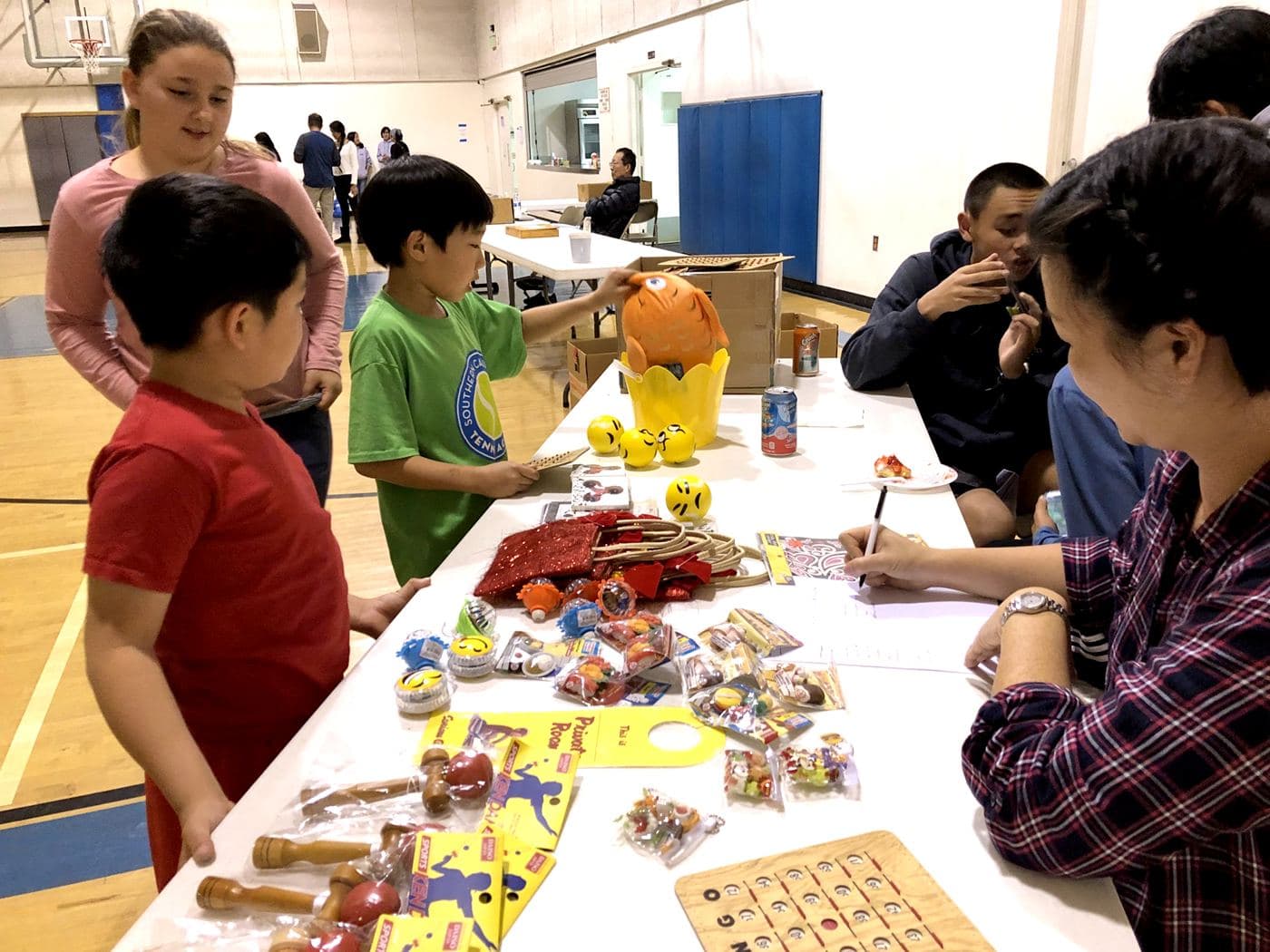 Children choosing prizes from the table on bingo night